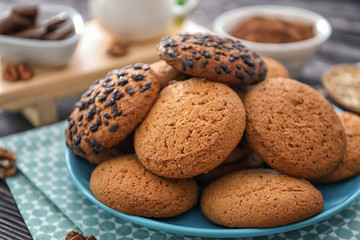 Plate with delicious oatmeal cookies on table, closeup