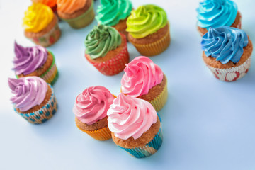 Tasty cupcakes on color background