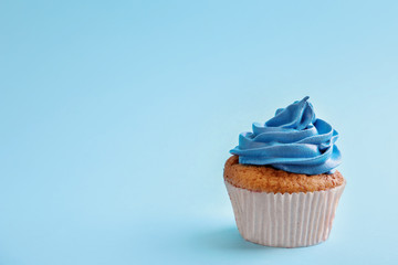 Tasty cupcake on color background