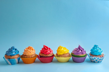 Tasty cupcakes on color background