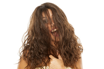 Young happy woman with her hair over her face