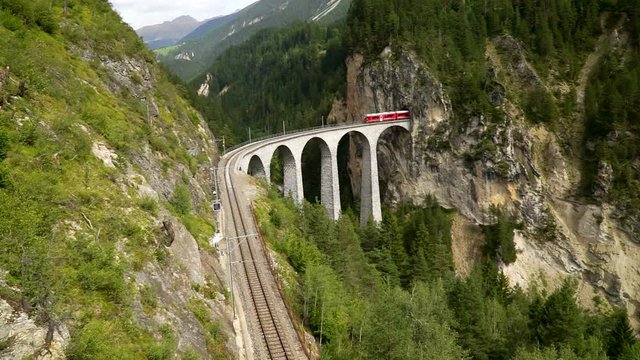 The train passes through the famous Landwasser viaduct in Switzerland. Top view.
