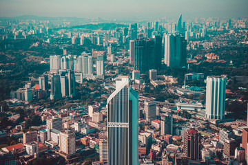 Modern architecture, business office building, cityscape background. Kuala Lumpur skyline. Travel to Malaysia. Urban skyscrapers. Modern city. Financial district. Aerial view of downtown. Toned