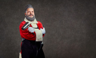 Santa Claus hairdresser barber with scissors and a hair dryer in his hands on the background of...