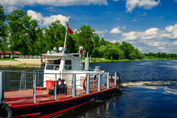 The river tug of red color that that transports on the river