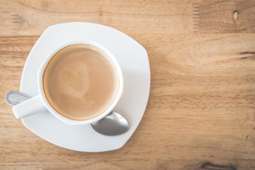 Top view of hot coffee latte on wood table background.