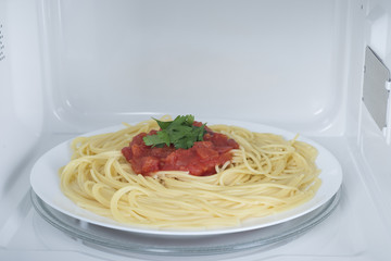 A new white microwave oven, on a blue wooden surface for heating food