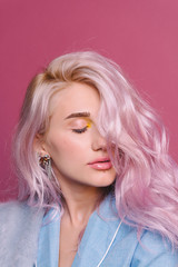 A studio close-up portrait of a beautiful sexy young hipster blonde girl with closed eyes, with...