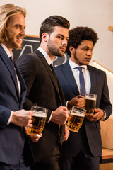 businessmen drinking beer in bar