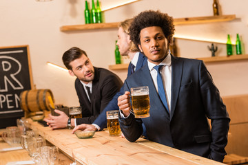 businessmen drinking beer in bar