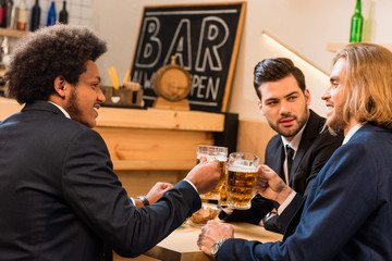 businessmen drinking beer in bar
