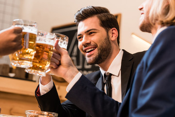businessmen clinking beer glasses