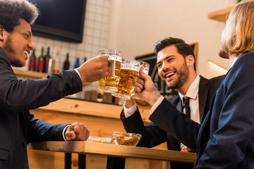 businessmen drinking beer in bar