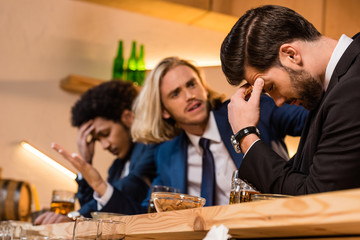 businessmen drinking beer in bar
