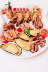 Close up of seafood platter. Fresh mixed seafood platter with salmon, tuna fillet, prawns, oysters, octopus and squids.