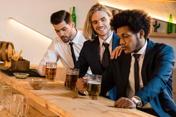 businessmen drinking beer in bar