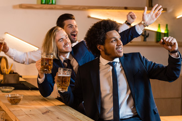 businessmen drinking beer in bar