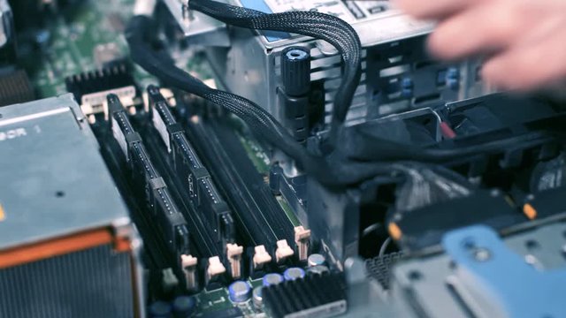 The Assembly of the computer. The engineer collects the server