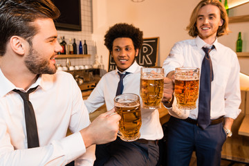 businessmen drinking beer in bar