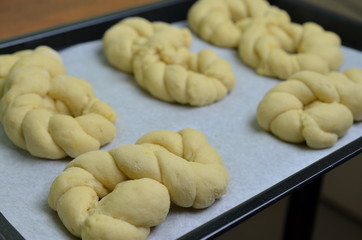 A batch of braided bread challah ready for the oven