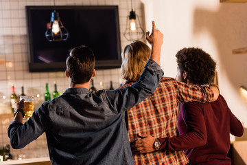 friends watching tv in bar