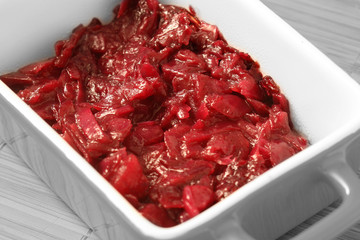 Pickled red cabbage in a ceramic serving dish with selective color