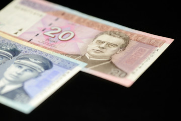 Banknotes of ten and twenty Lithuanian litas on a dark background