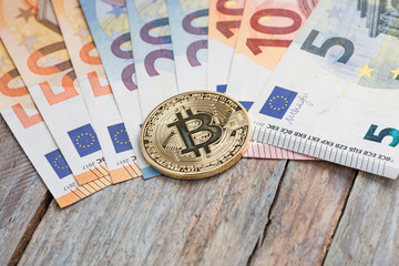 Bitcoin on Euro banknotes at table