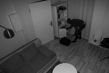 Robber Searching House For Valuables