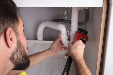 Man Repairing Sink Pipe Leakage