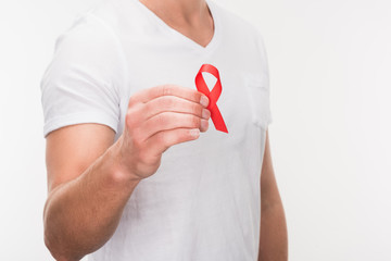 man holding aids ribbon