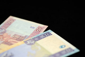 Banknotes of ten and twenty Lithuanian litas on a dark background