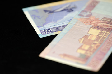 Banknotes of ten and twenty Lithuanian litas on a dark background
