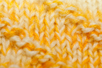 Background of close-up yellow-white knitted canvas.