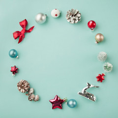 Fototapeta na wymiar Circle frame of Christmas decorations on pale blue background, flatlay