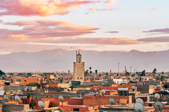 panoramic views of marrakech medina with atlas mountain range at background, morocco