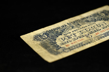 An obsolete banknote in five Czechoslovak krones on a dark background