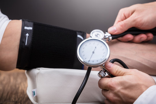 Doctor Checking Patient's Blood Pressure