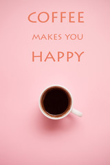 cup of coffee on pastel background with quotes