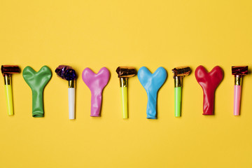 Party balloons on a bright yellow background