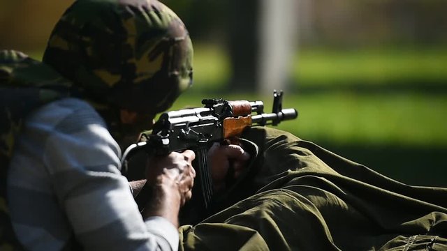 Outdoor shooting with automatic rifle in a shooting range