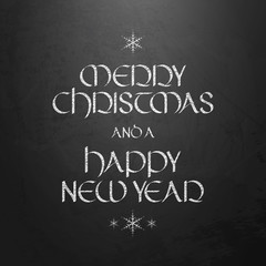Fototapeta na wymiar MERRY CHRISTMAS and a HAPPY NEW YEAR uncial calligraphy on chalkboard