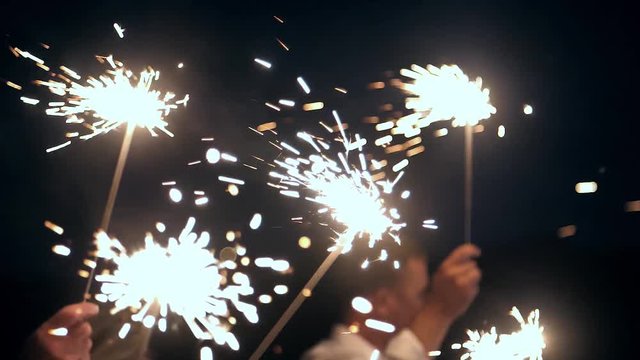 People with sparklers in slow motion.