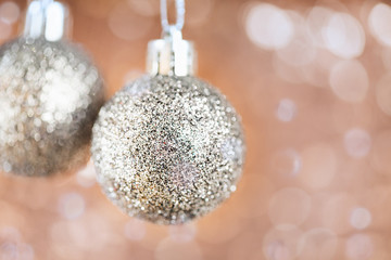 Shining Christmas balls on abstract shimmering bokeh background