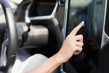 A young girl presses buttons on electric vehicle control devices.