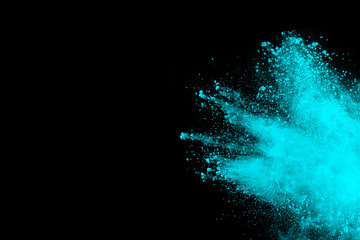 abstract green powder explosion on black background. Freeze motion of green powder splash. Green dust splattered on background.