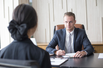 Business man interview woman for job register at office.