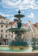 Fototapeta na wymiar Fountain in Rossio square at Lisbon.