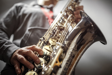 Saxophonist playing a saxophone - obrazy, fototapety, plakaty