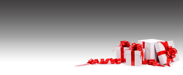 three christmas gift white box with red bow and ribbon on a faded grey background and empty space for text